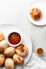 Overhead view of a plate of masa and pepper sauce, top view of food from northern nigeria masa rice cake and stew, nigerian ethnic foods