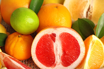 Different tasty citrus fruits as background, closeup