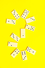 White dominos blocks on yellow background
