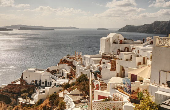 Scenic view of Santorini's iconic whitewashed buildings cascading down the volcanic cliffs above the Aegean Sea. The picturesque Greek island is renowned for its traditional Cycladic architecture, bre