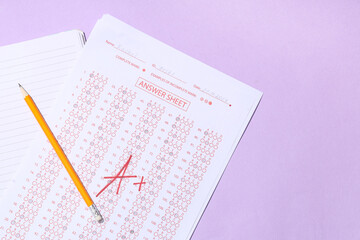 Pencil, notebook and answer sheets form of school test with results on lilac background
