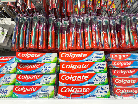 VALENCIA, SPAIN - APRIL 6, 2025: Colgate toothpaste boxes and toothbrushes in a supermarket in Valencia, Colgate is an american brand of oral hygiene and tooth cleaning products such as toothpaste.