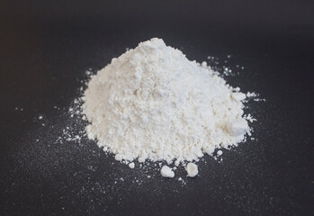 pile of flour powder isolated on black background