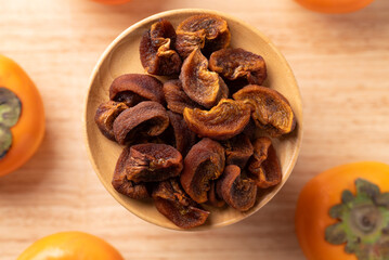 Dried persimmon on wooden plate ready to eating, Sweet and chewy, Table top view