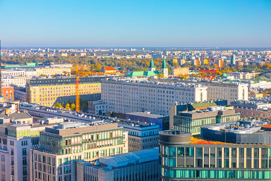 Fototapeta Aerial view of modern city of Warsaw, Poland. Urban landscape is mixture of contemporary glass buildings and multi-story structures extending toward the horizon, dense development of the capital city
