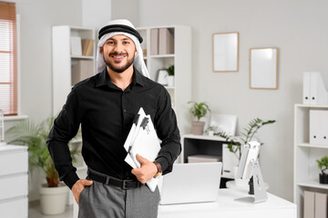 Arab businessman with papers in office