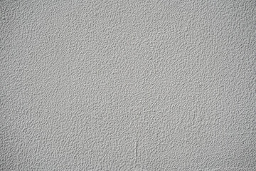 Uniform gray rough stucco wall texture, blank monochromatic background for design overlay.
