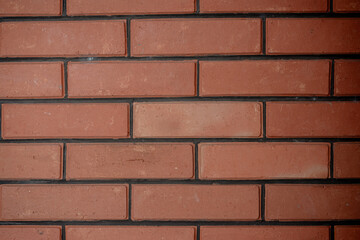 Close up detail of red brick wall texture, solid masonry construction background with wide format.