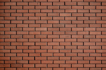Classic red brick wall texture, brown masonry construction background pattern with dark joints.