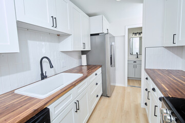 Beautiful white kitchen with stainless steel appliances