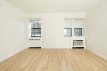 Bright empty white room with natural wood floors