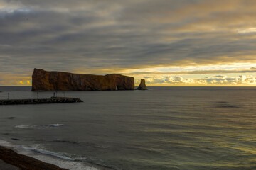 Breathtaking sunrise over Perce Rock, Gaspe Peninsula, Quebec. Captured in stunning morning light, this iconic landmark offers a serene and picturesque view.