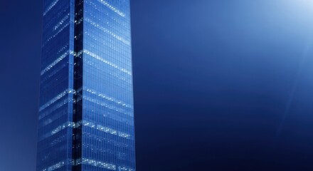 Modern architecture skyscraper against a dark blue night sky background