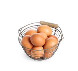 Basket with brown chicken eggs on white background