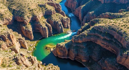 Aerial View of a River Carving Through a Canyon Landscape.