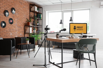 Interior of podcaster's studio with workplace, armchairs and plants