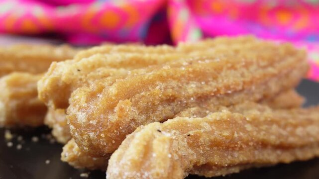 Travel to the close-up of churros on a plate of Mexican food