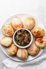 Overhead view of a plate of masa and gas meat, top view of food from northern nigeria masa and grilled meat