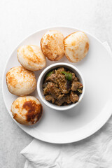 Overhead view of a plate of masa and gas meat, top view of food from northern nigeria masa and grilled meat