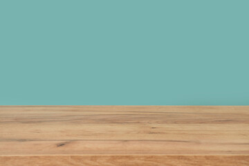 Empty wooden surface against mint background, closeup
