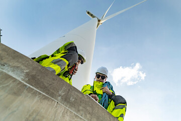 Team of engineers in reflective work suits join hands to inspect and demonstrate their work and...