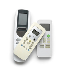 Modern air conditioner remote controls isolated on white background, top view