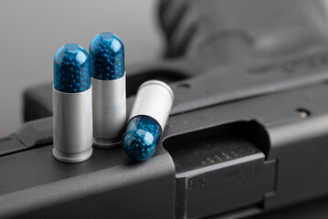 9 mm. Shotshells or birdshot ammunition with pistol gun background , Small birdshot bullets ,  Snake-killing bullets