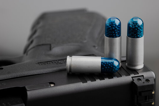 9 mm. Shotshells or birdshot ammunition with pistol gun background , Small birdshot bullets ,  Snake-killing bullets