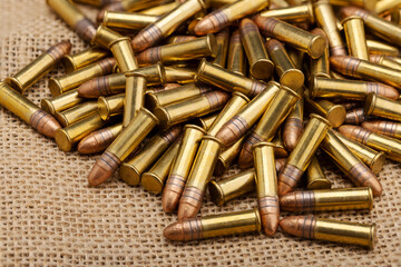 Close up of .22 ammunition on burlap background , .22 LR bullets
