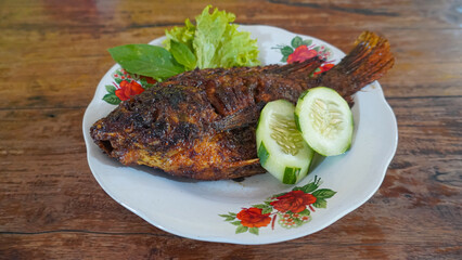 Traditional Indonesian Grilled Tilapia Fish Serving with Garnish