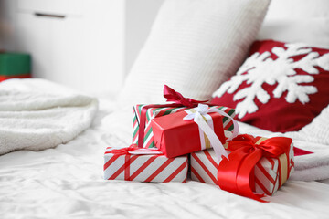 Christmas gifts on bed in room, closeup
