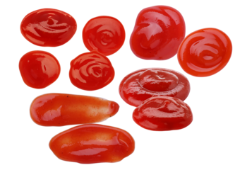 high-contrast photograph of various red tomato ketchup or sauce dollops and smears dramatically isolated on a solid transparent background.