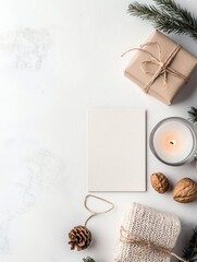 A flat lay composition featuring winter holiday elements like a gift, candle, and natural decor, suggesting a warm and festive atmosphere.