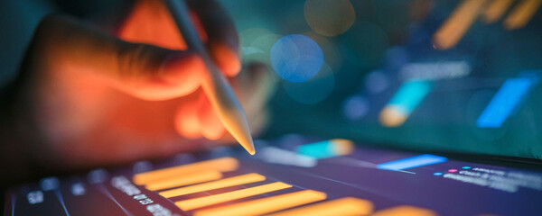 Analyzing financial data on a tablet with a stylus for business insights