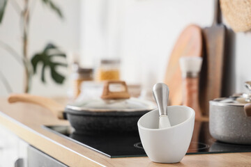 Mortar with pestle on counter in kitchen, closeup