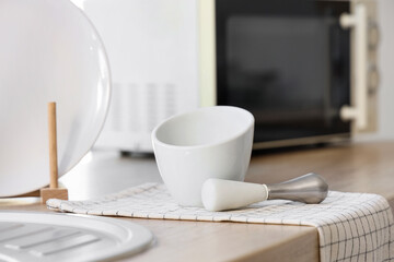 Mortar with pestle on counter in kitchen, closeup