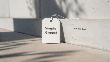 Minimalist White Tag on Concrete Surface with Text Simple Ground and Soft Shadow in Natural Lighting