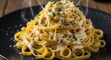 Steaming Fettuccine Alfredo with Parmesan and Fresh Parsley on a Dark Plate.