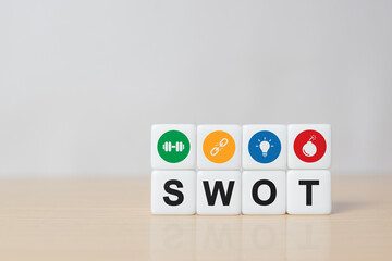 SWOT analysis and strategic planning technique concept. SWOT words means Strengths, Weaknesses, Opportunities and Threats on dice with grunge grey background including copy space
