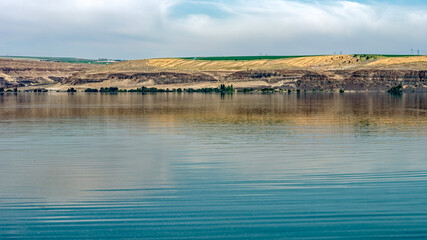 The colors of the basalt bluffs reflected in the Columbia River in the Palouse region of Washington state