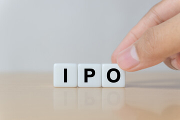 Businessman hand holding IPO (Initial Public Offering) word with dice, shares of a private corporation to the public in a new stock issuance. Stock, Fund, Investors and Investment concept