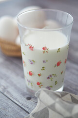 Fresh milk in a decorative glass on a rustic table