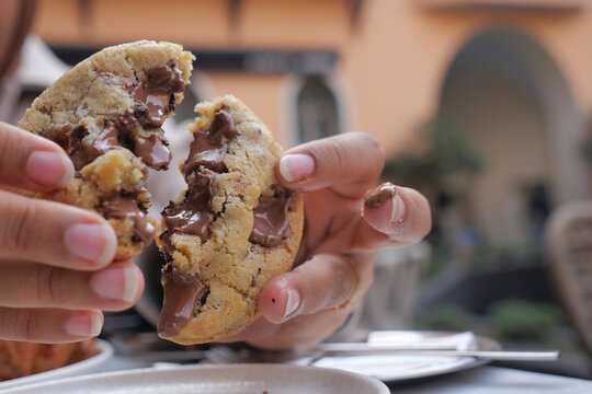 Freshly baked cookie pulled apart to reveal melted chocolate