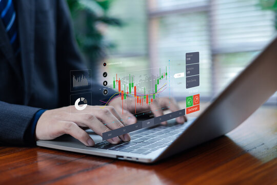 Business professionals analyzing real-time trading data on laptops with digital financial charts, market analysis and investment indicators, demonstrating modern online trading.
