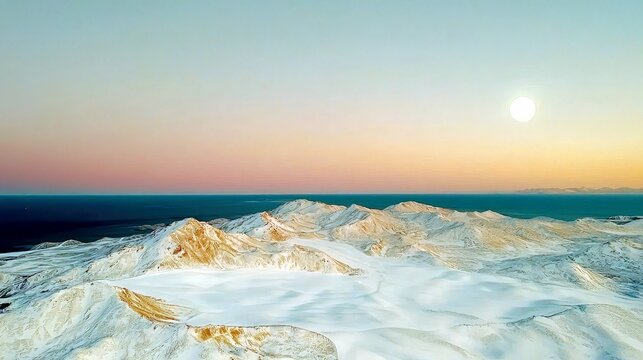 A vast, snow-covered mountain landscape meets a tranquil ocean under a soft, gradient sky illuminated by a bright sun.