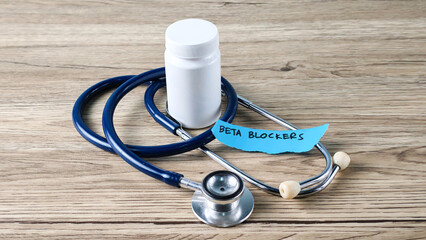Beta Blockers Medication Bottle and Stethoscope on Wooden Background Representing Heart Health and...