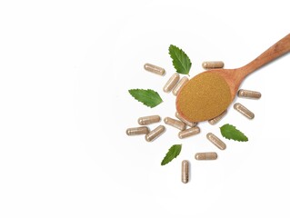 Herbal capsules on wooden spoon isolated on white background. Organic supplements for health, Flat lay. Copy space 