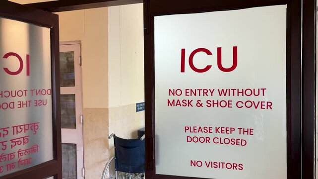 hospital icu entrance with safety instructions on glass door