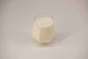 Glass of almond milk isolated on white background with clipping path for vegan beverage or healthy drink concept