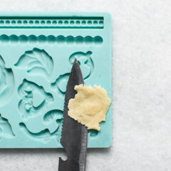 overhead view of vanilla sugar cookie dough in a blue silicone mould, top view of plain vanilla cookie dough in a mold